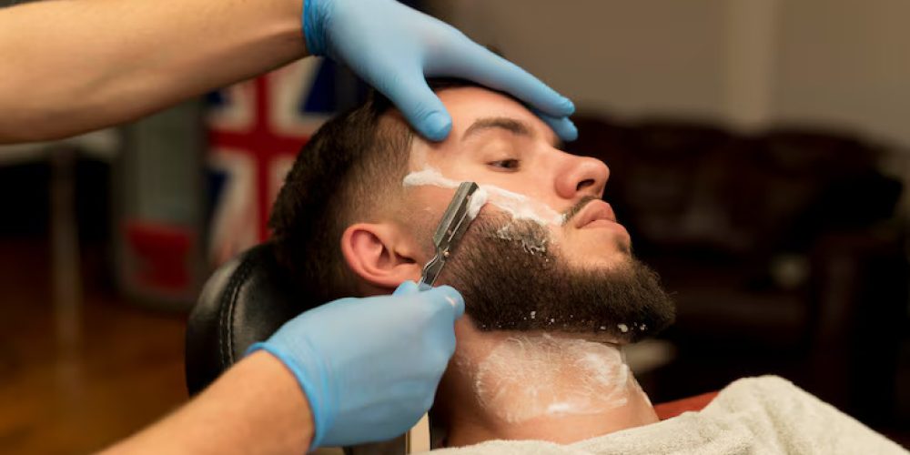 barber-shaving-contouring-male-customer-s-beard_23-2148985742