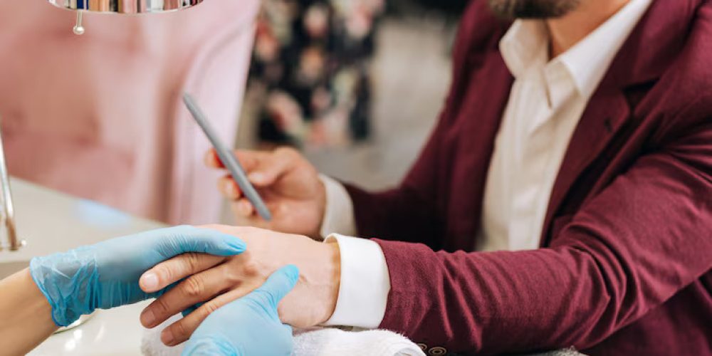 close-up-female-hands-hydrating-male-hands-dressing-blue-gloves_259150-32301