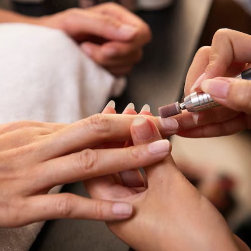 high-angle-woman-getting-manicure_23-2149975499