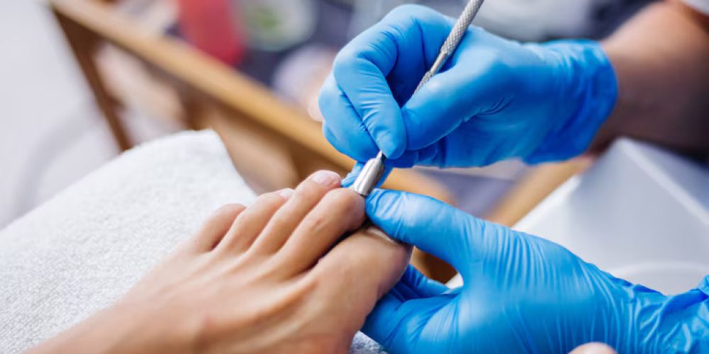 pedicure-process-home-salon-pedicure-foot-care-treatment-nail-process-professional-pedicures-master-blue-gloves-make-pedicure_343596-1601